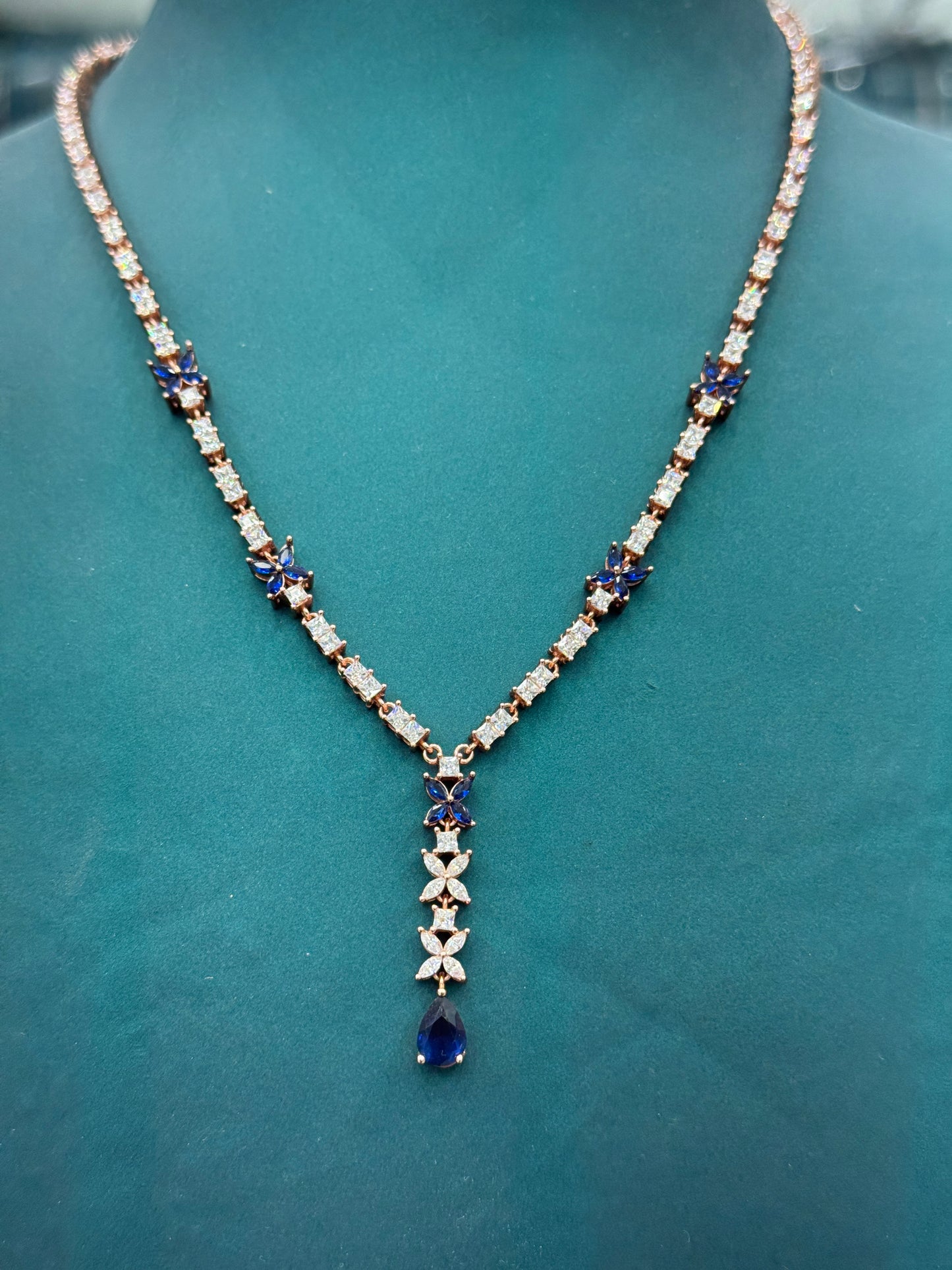Butterfly motifs and teardrop-shaped blue sapphires look -alike