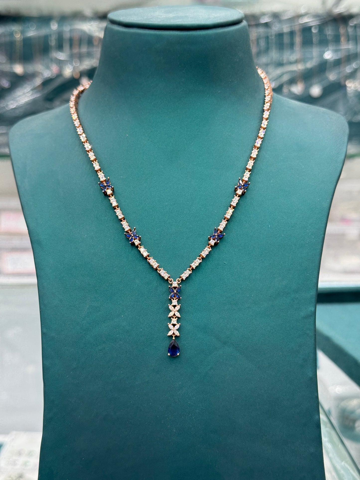 Butterfly motifs and teardrop-shaped blue sapphires look -alike